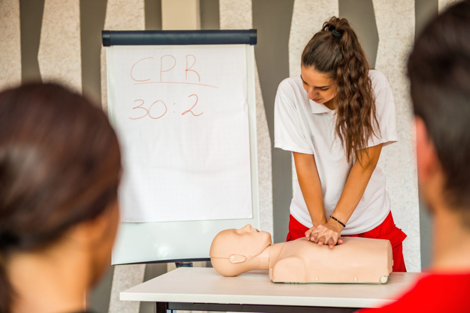 Woman instructor leading a CPR training class